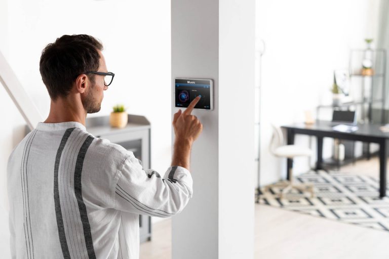 Heating Contractor in Manchester configures a Thermostat in residential house