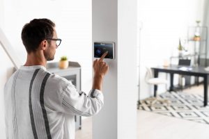 Adjusting a Smart Thermostat installed by Manchester's #1 HVAC Company